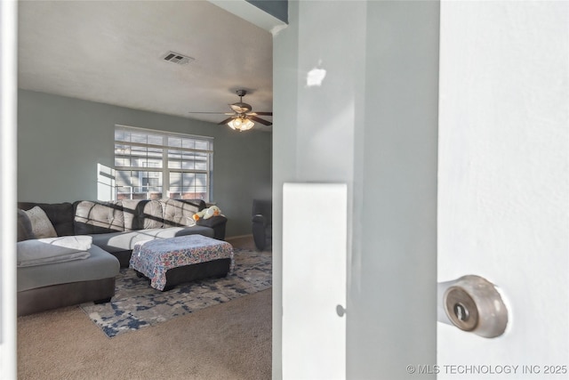 living room featuring ceiling fan and carpet