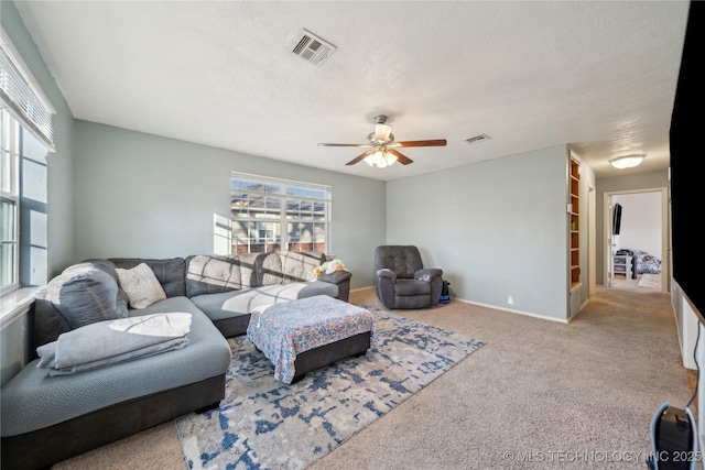 living room with ceiling fan and light carpet