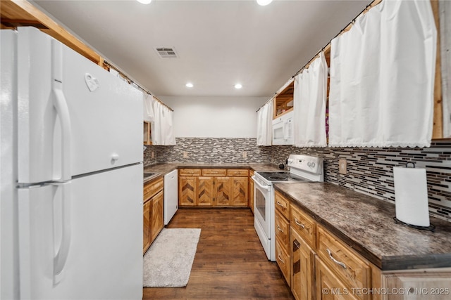 kitchen with backsplash, white appliances, and dark hardwood / wood-style flooring