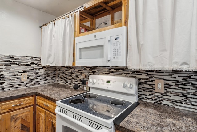 kitchen featuring white appliances and tasteful backsplash