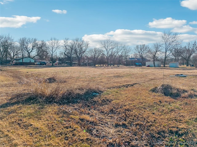 view of yard with a rural view