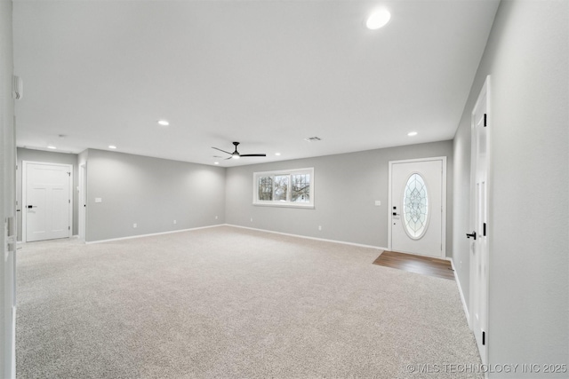 entrance foyer with light carpet and ceiling fan