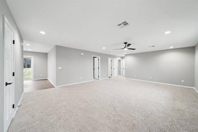 carpeted empty room featuring ceiling fan