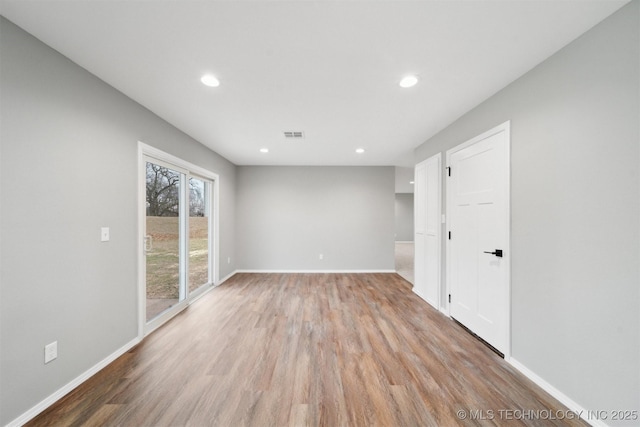 empty room with light hardwood / wood-style flooring