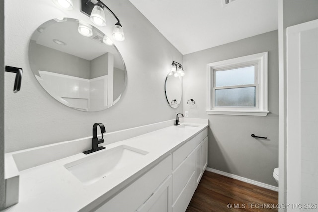 bathroom with vanity, hardwood / wood-style flooring, toilet, and walk in shower