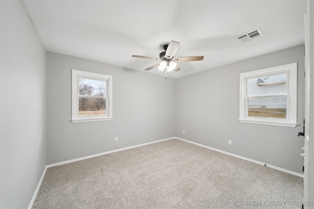 spare room with carpet floors and ceiling fan