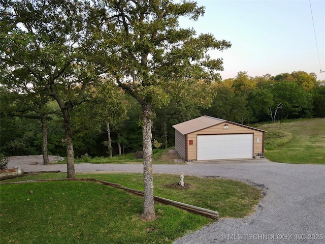 exterior space with a front yard, an outdoor structure, and a garage