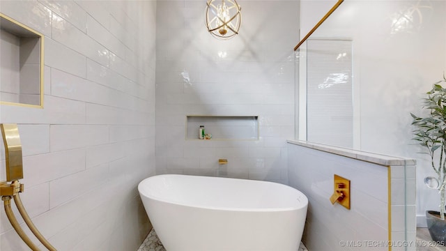 bathroom featuring a bathtub and tile walls