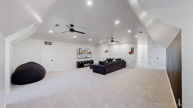 home theater room with ceiling fan, light colored carpet, and lofted ceiling