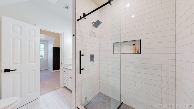 bathroom featuring vanity, toilet, tile patterned floors, and walk in shower