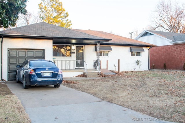 view of front facade with a garage and a porch