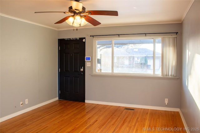 entrance foyer featuring ornamental molding, ceiling fan, and light hardwood / wood-style flooring