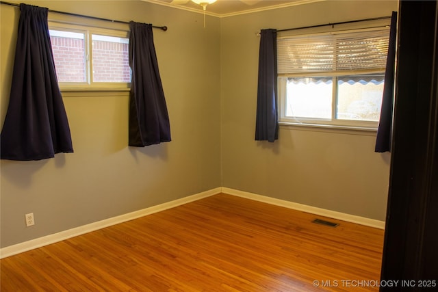 spare room with ornamental molding, hardwood / wood-style floors, and ceiling fan