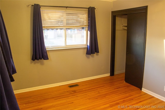 unfurnished bedroom with light hardwood / wood-style floors and a closet