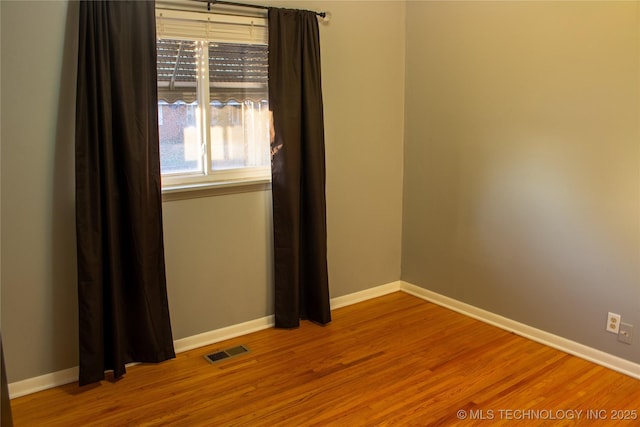 unfurnished room with hardwood / wood-style floors