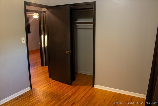 unfurnished bedroom featuring light wood-type flooring and a closet