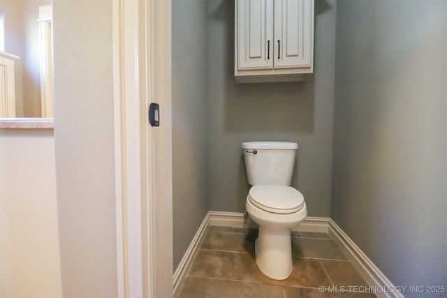 bathroom with tile patterned flooring and toilet