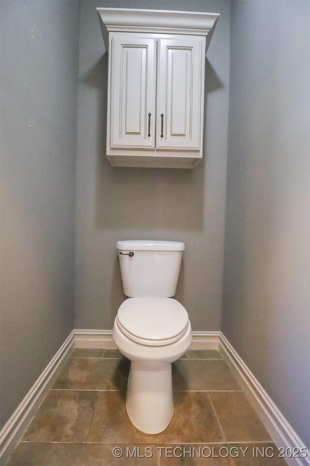 bathroom with tile patterned flooring and toilet