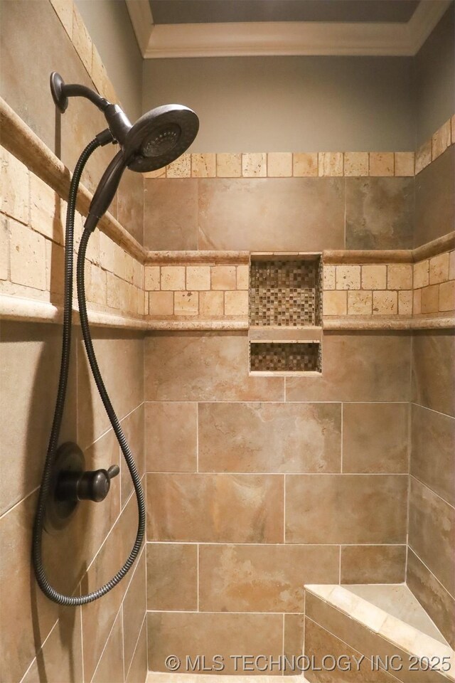 details with ornamental molding and a tile shower