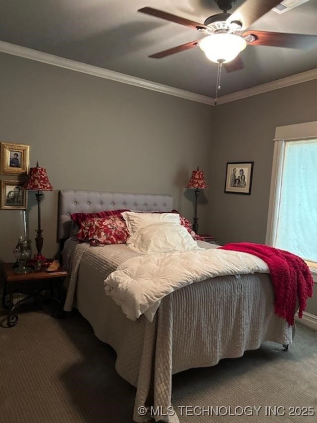 bedroom featuring ceiling fan, ornamental molding, and carpet flooring