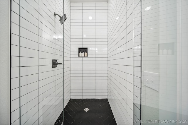 bathroom with tiled shower