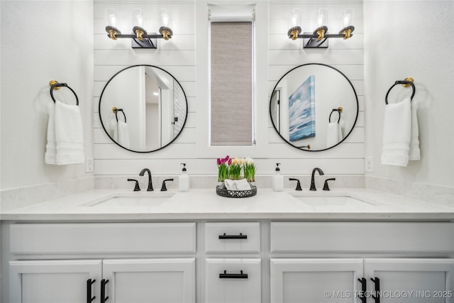 bathroom featuring vanity and wooden walls