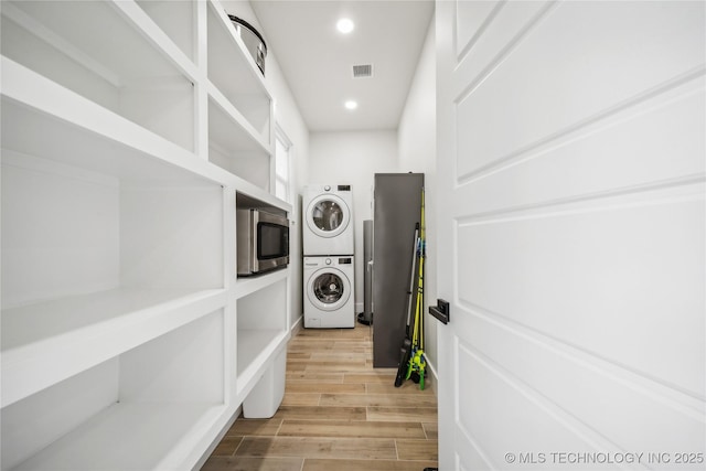 laundry room featuring stacked washer / drying machine