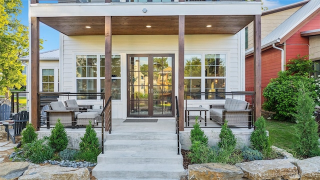 view of exterior entry featuring an outdoor hangout area and french doors