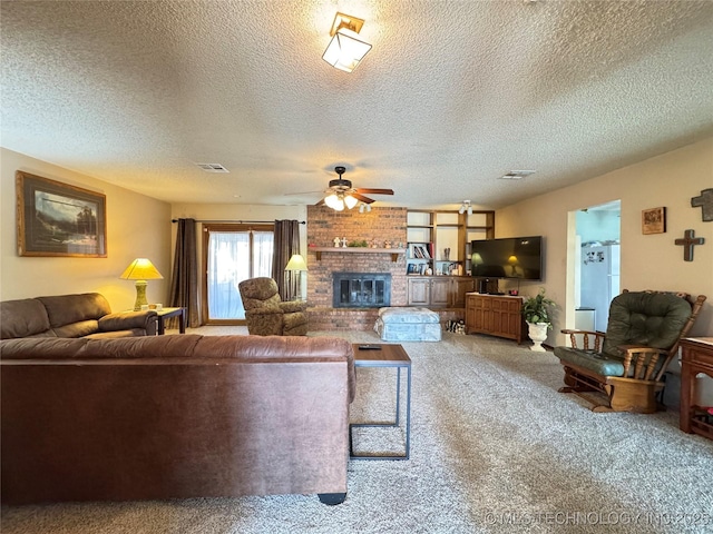 living room featuring ceiling fan, carpet floors, a textured ceiling, and a fireplace