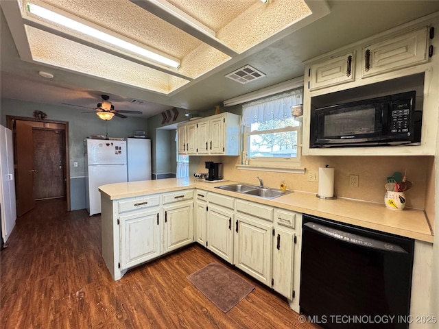 kitchen featuring sink, kitchen peninsula, dark hardwood / wood-style floors, and black appliances