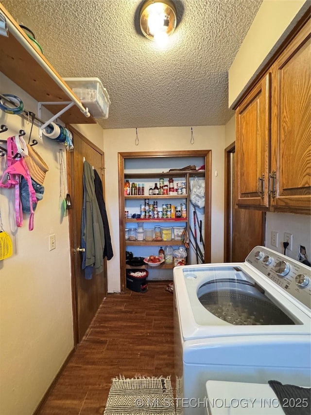 washroom featuring dark hardwood / wood-style floors, cabinets, washer / clothes dryer, and a textured ceiling