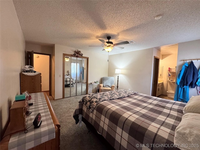 bedroom featuring ceiling fan, carpet, and a textured ceiling