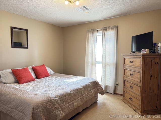 carpeted bedroom featuring a textured ceiling