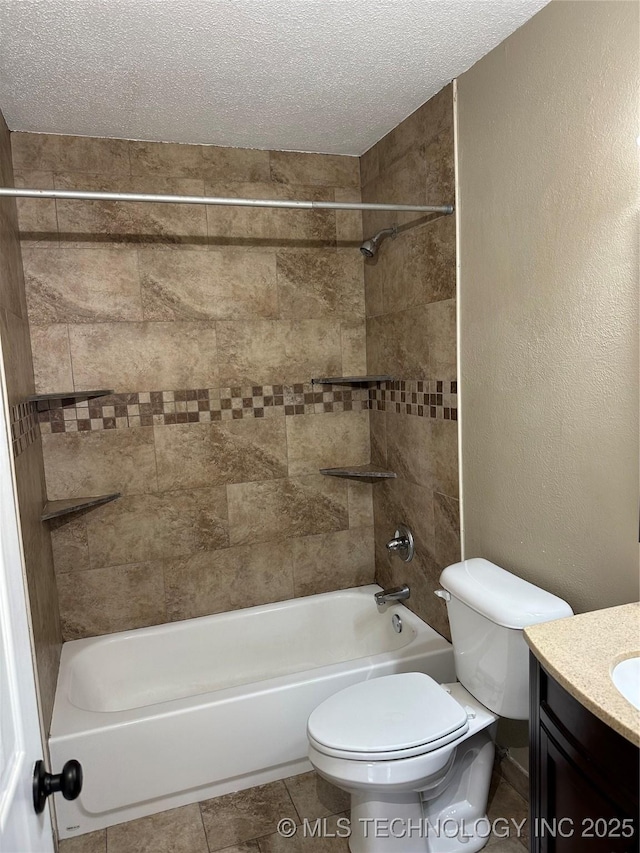 full bathroom featuring vanity, tiled shower / bath, a textured ceiling, and toilet