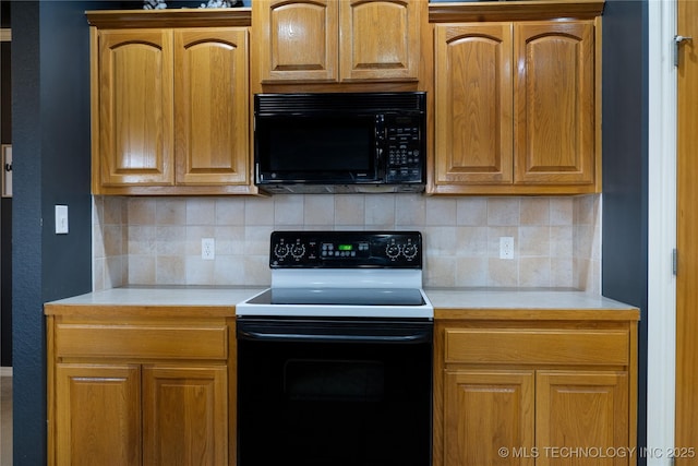 kitchen featuring tasteful backsplash and black appliances