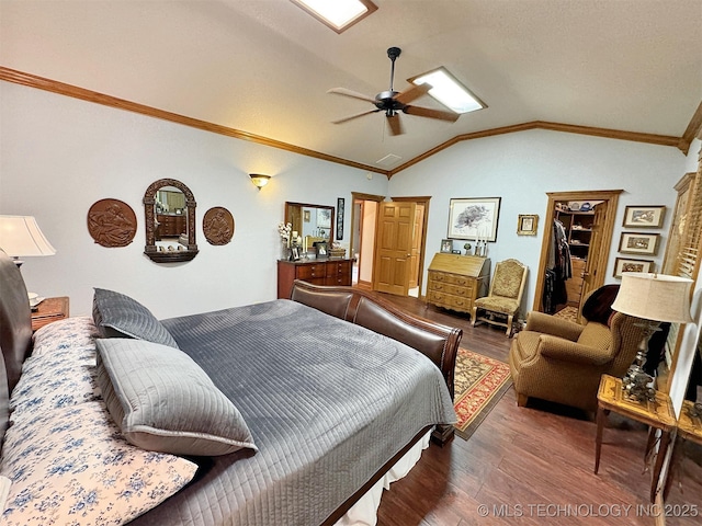 bedroom with lofted ceiling, a spacious closet, ornamental molding, dark hardwood / wood-style floors, and ceiling fan