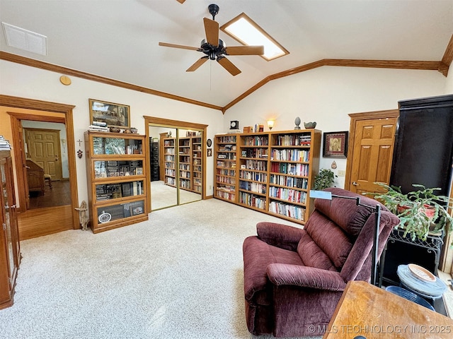 living area with vaulted ceiling, ceiling fan, and carpet flooring