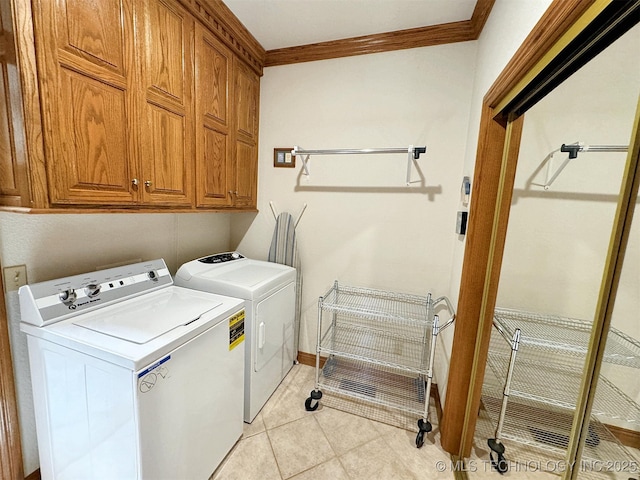 laundry room with cabinets, independent washer and dryer, ornamental molding, and light tile patterned flooring