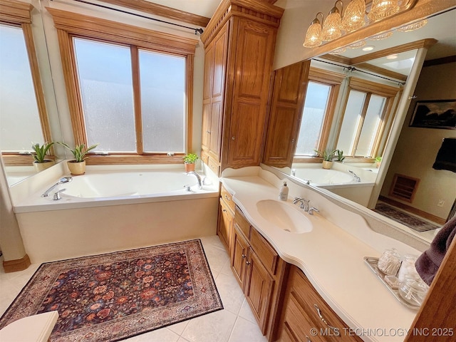 bathroom featuring tile patterned floors, vanity, and a tub