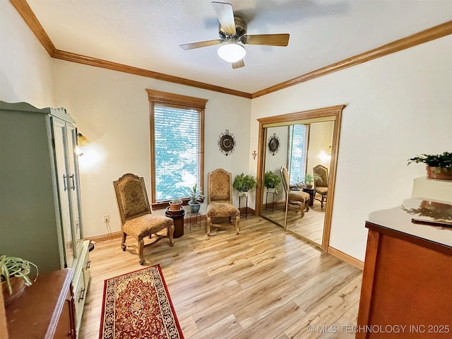 living area featuring crown molding, ceiling fan, and light hardwood / wood-style floors