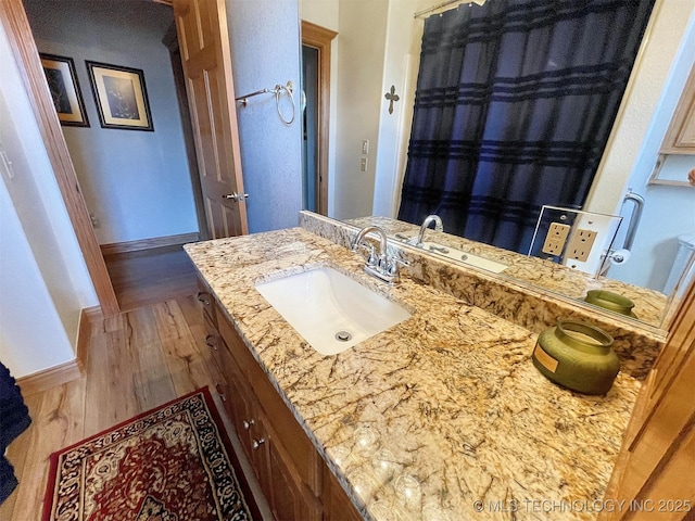 bathroom featuring wood-type flooring and vanity