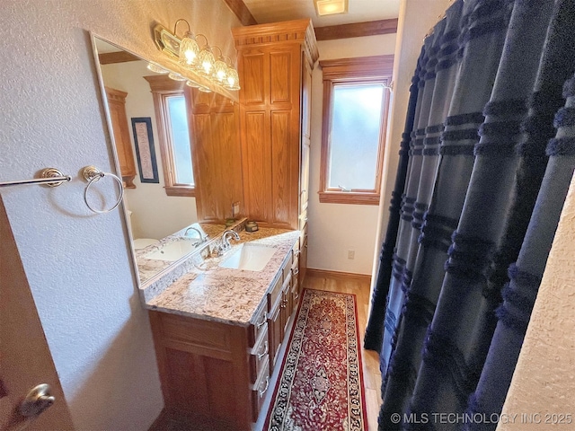 bathroom featuring vanity and hardwood / wood-style flooring