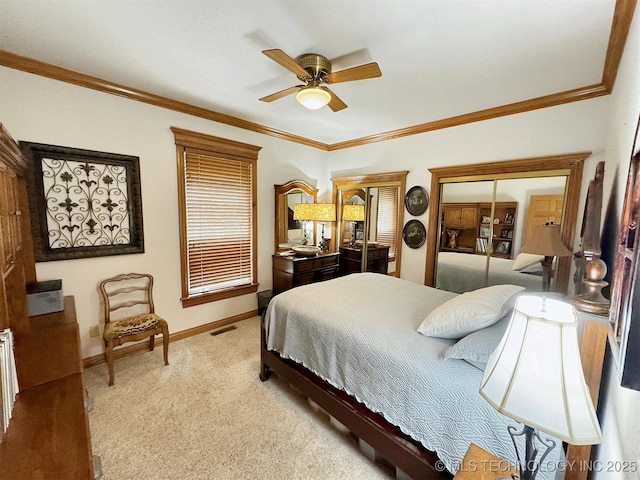 bedroom with crown molding, ceiling fan, and light colored carpet