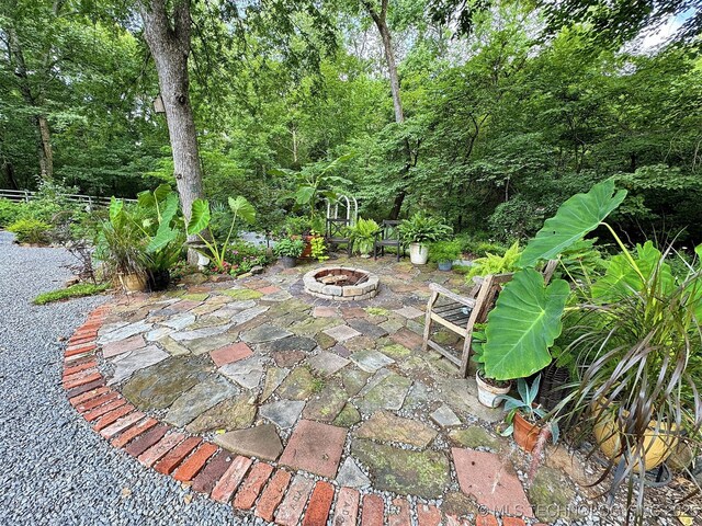 view of patio / terrace featuring an outdoor fire pit