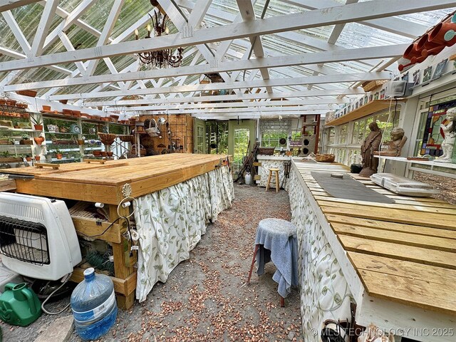 miscellaneous room featuring lofted ceiling and heating unit