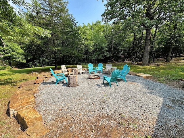 view of play area with a fire pit and a patio area