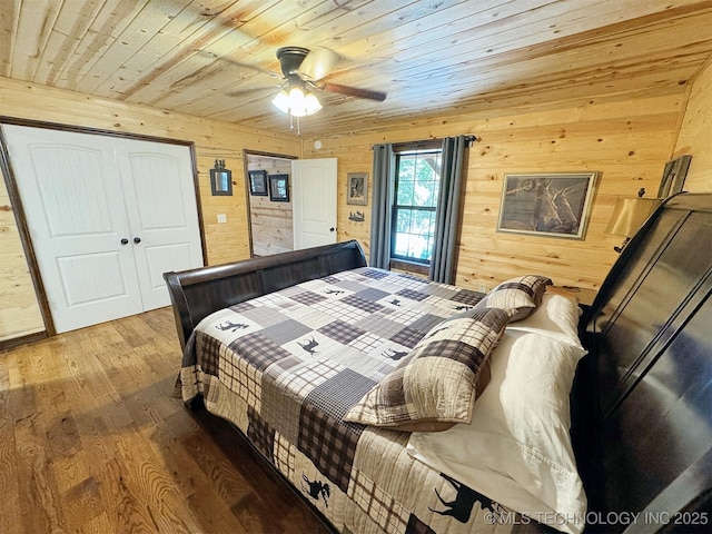 bedroom featuring wood-type flooring, wood ceiling, wooden walls, and ceiling fan