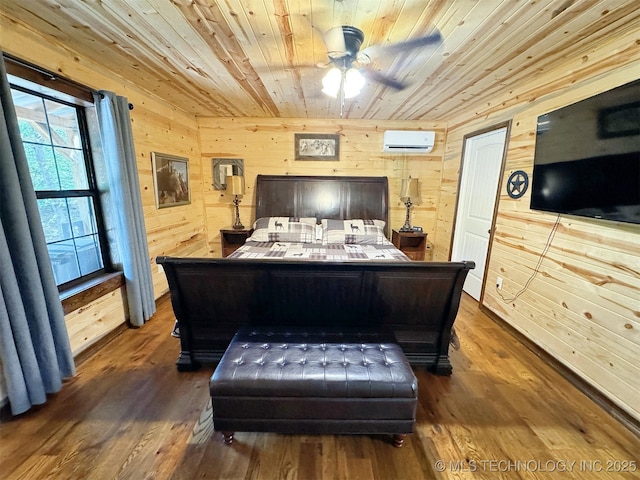 bedroom with wood walls, an AC wall unit, wooden ceiling, ceiling fan, and hardwood / wood-style floors