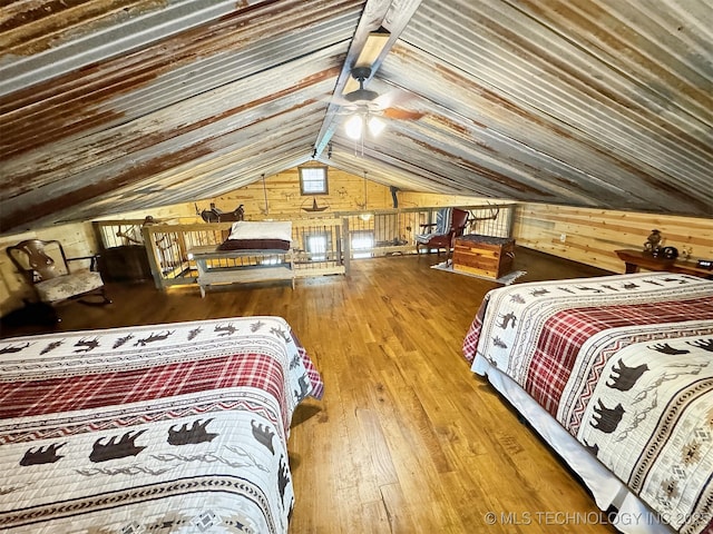 bedroom with vaulted ceiling, wood walls, wood-type flooring, ceiling fan, and wooden ceiling