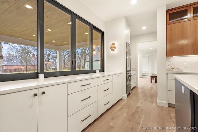 bathroom with hardwood / wood-style flooring and backsplash